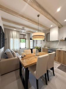 a kitchen and dining room with a table and a couch at El Cortijillo 503 in Almuñécar