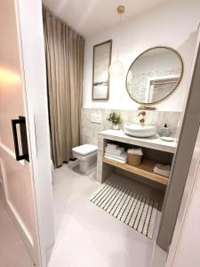 a bathroom with a sink and a mirror at El Cortijillo 503 in Almuñécar