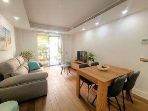 a living room with a couch and a table at Luxury Conde Ofalia by Expovivienda in Almería