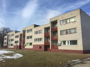 two brick apartment buildings with snow on the ground at Holiday apartment Helena in Kõrgessaare
