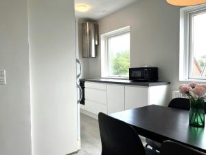 a kitchen with a dining table and a microwave at Spacious Apartment for 4 in Aalborg