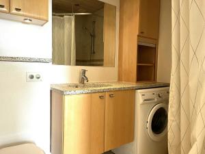 a bathroom with a sink and a washing machine at Spacious Apartment for 4 in Aalborg