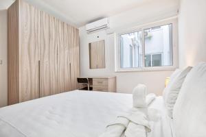 Un dormitorio blanco con una cama blanca y una ventana. en Mercury Residence No15 Penthouse Terrace by Haven & Keys Malta, en Sliema