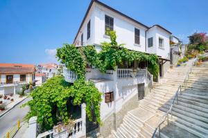 a building with ivy growing on the side of it at Rustic Villa 2 Min walk to the beach heart of Limenaria in Limenaria