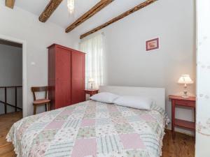 a bedroom with a bed and a red cabinet at Antica holiday house with pool, sea view in Savar +22 photos