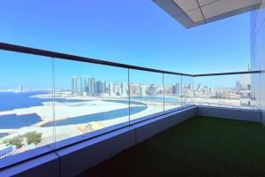 a large balcony with a view of the city at Blue Seaview 75 inch Smart TV 1Br in Manama