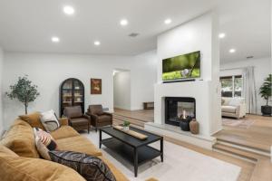 a living room with a couch and a fireplace at Spacious 3BR Yavapai Retreat with Nature Views, Hot Tub and Game Room in Sedona