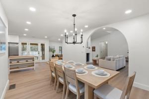 a dining room and living room with a table and chairs at Spacious 3BR Yavapai Retreat with Nature Views, Hot Tub and Game Room in Sedona