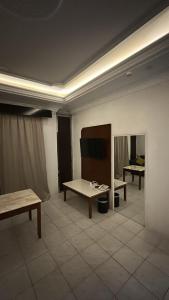 a room with a table and a tv in it at فندق نسيم أبها in Abha