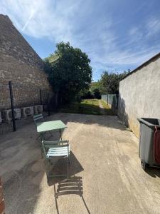 a picnic table and a bench in a parking lot at Albert I Ground floor l Terrace l Garden l Air conditioning in Castres