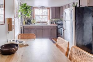 a kitchen with a wooden table and a large refrigerator at Downtown Lakefront Hideaway in Burlington