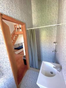 a bathroom with a sink and a shower with a mirror at Quinta Maria Gil - B in Lourinhã