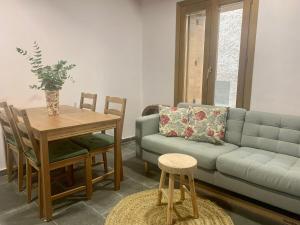 a living room with a couch and a table at La Caseta del Pont in Camprodon