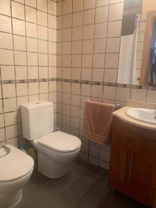 a bathroom with a toilet and a sink at La Caseta del Pont in Camprodon