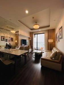 a living room with a couch and a table at LAD Apartment & Homestay Hai Phong - Hoàng Huy Commerce Vo Nguyen Giap in Hai Phong