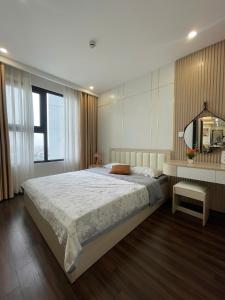 a bedroom with a large bed and a television at LAD Apartment & Homestay Hai Phong - Hoàng Huy Commerce Vo Nguyen Giap in Hai Phong