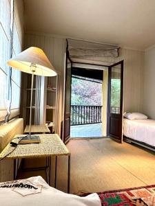 a room with a bed and a table with a lamp at Torre de las Águilas, Bellver, Puigcerdá in Bellver de Cerdanya 