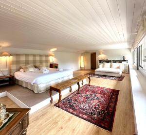 a large bedroom with two beds and a rug at Torre de las Águilas, Bellver, Puigcerdá in Bellver de Cerdanya