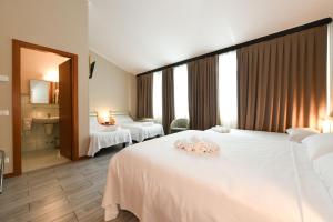 Postel nebo postele na pokoji v ubytování Hotel Garda
