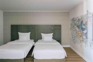 Letto o letti in una camera di Pentahotel Leipzig