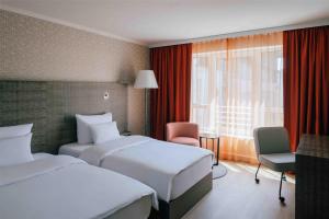 Letto o letti in una camera di Pentahotel Leipzig
