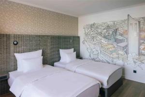 Letto o letti in una camera di Pentahotel Leipzig