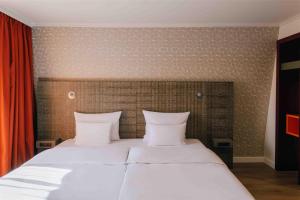 Letto o letti in una camera di Pentahotel Leipzig