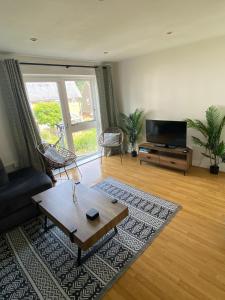 a living room with a couch and a coffee table at The Dover House with river and Castle views in Dover