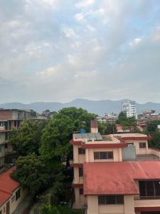 a view of a city with buildings and trees at Bansbari Warm Home in Kathmandu