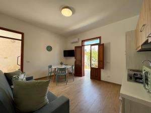 a living room with a couch and a table at Appartamento Ciliegio in San Vito lo Capo +10 photos