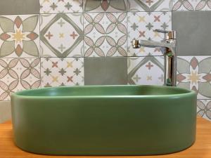a green sink with a faucet in a bathroom at Appartamento Ciliegio in San Vito lo Capo