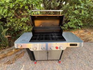 a barbecue grill sitting on a brick sidewalk at Vue mer - Grimaud, France in Port Grimaud