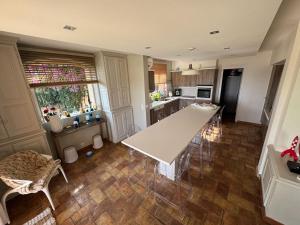 a kitchen with a white table and chairs in it at Vue mer - Grimaud, France in Port Grimaud