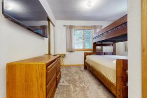 a bedroom with a bunk bed and a dresser at Snowdance Condo A101 in Keystone