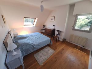 Ένα ή περισσότερα κρεβάτια σε δωμάτιο στο Maison Familiale en bord de mer