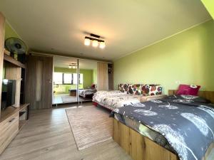 a bedroom with a large bed and a couch at SouthBrise Apartments - Garsoniera Mangalia - 100m de plajă in Mangalia