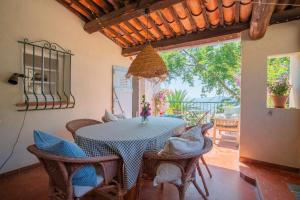 a dining room with a table and chairs at Lilie House in Bormes-les-Mimosas +10 photos