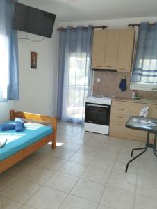a kitchen with a bed and a table in a room at Villa Platskos vol3 in Kriopigi