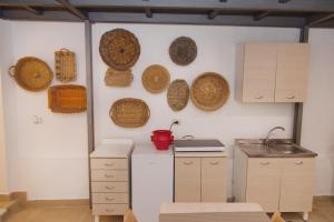 a kitchen with baskets hanging on the wall at Casa Gisella in Trani