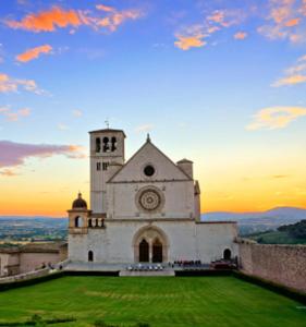a church on a hill with a sunset in the background at Narni Fabi Home in Narni