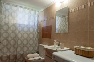 a bathroom with a toilet and a sink and a mirror at Moiras apartments in Lefkada +131 photos