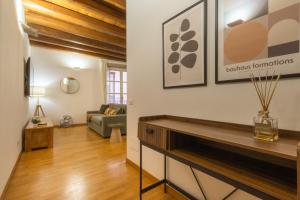 a living room with a fireplace and a couch at Martini Castello Boutique Apartments - Historic Center & Lift in Cagliari +40 photos