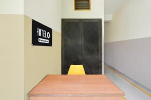 a meeting room with a desk and a door at Super Hotel O Villivakkam Railway Station Formerly BV Stayz in Chennai