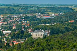 an aerial view of a town with a building on a hill at The Houses - Chata u sjezdovky 2 in Velké Meziříčí