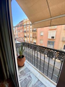 a balcony with a view of a building at La Vega Rooms in Huelva +47 photos