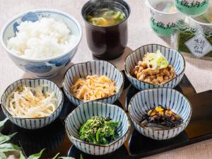 a group of bowls of food on a table at APA Hotel Roppongi SIX in Tokyo
