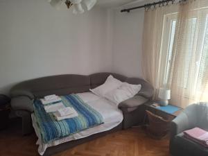 a couch in a living room with towels on it at Anako in Novi Vinodolski
