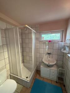 a bathroom with a shower and a sink at Rusałka Domek nad Jeziorem in Rudno +55 photos