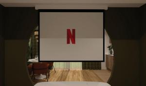 a large screen with the letter n on it in a room at Escape - Suite with Balneo and Sauna - Downtown in Pontarlier