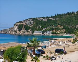 a view of a beach with a mountain in the background at Anxhelos Hotel in Himare